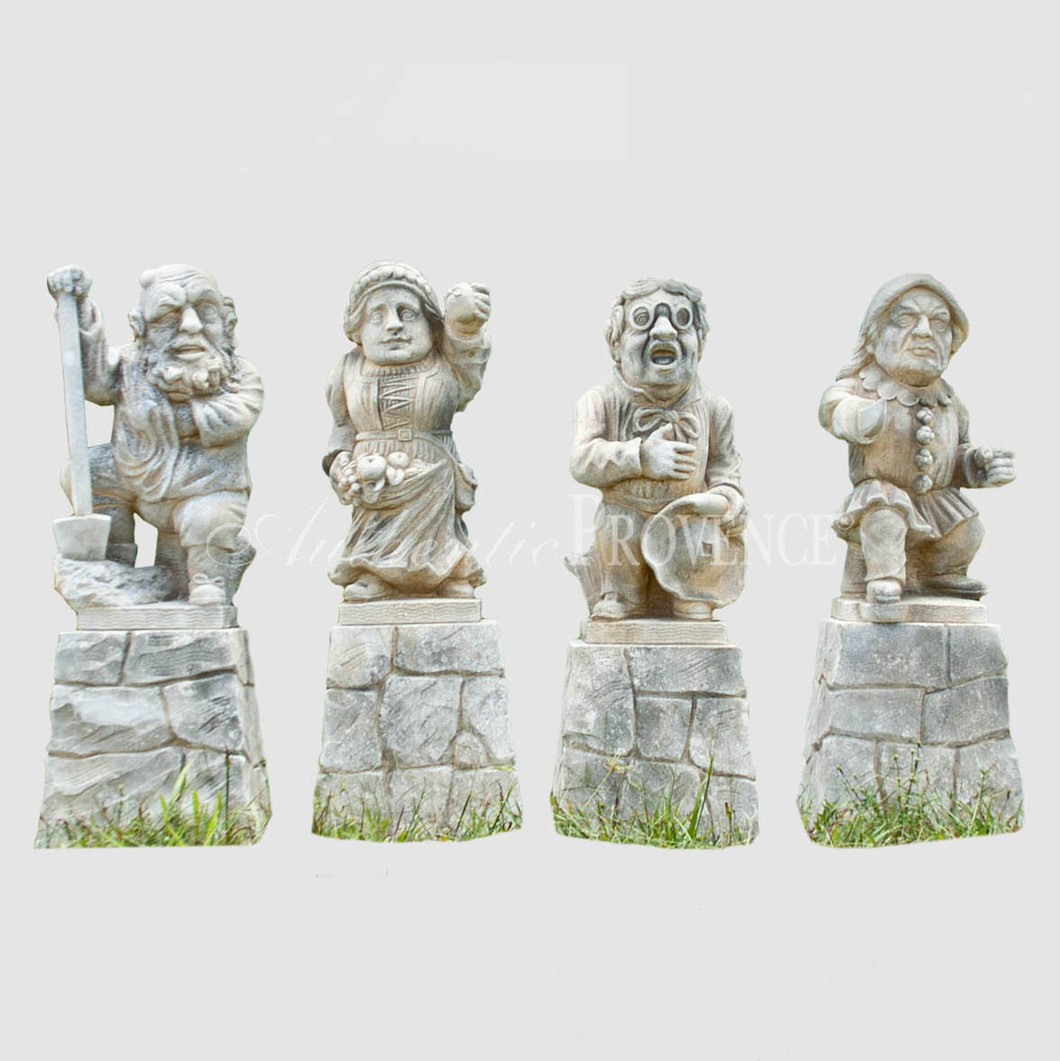 A set of four dwarf statues on original bases. Hand carved in limestone with nicely aged patina